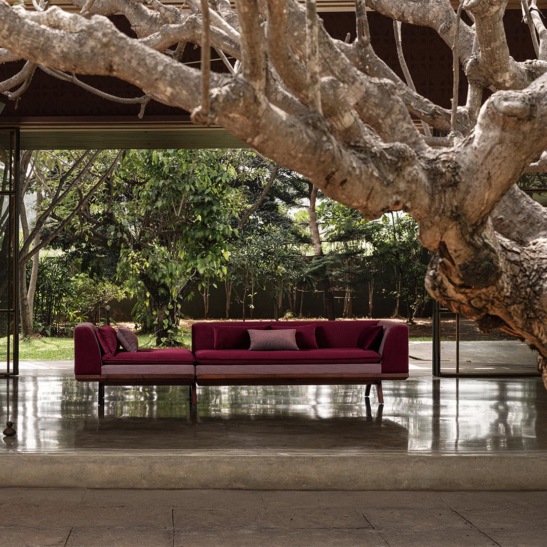 A wide shot of the Krithi Daybed, placed as a central statement piece in a contemporary home setting, embodying comfort and sculptural elegance.