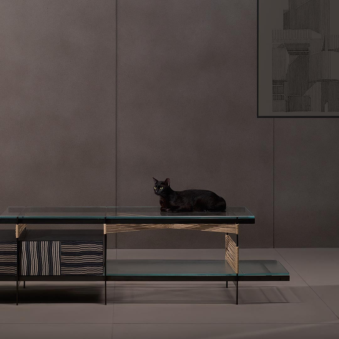 Kairos media console from Magari's IVAI Collection in a luxurious living room, featuring layered glass shelves, push-to-open drawers, and sophisticated styling.