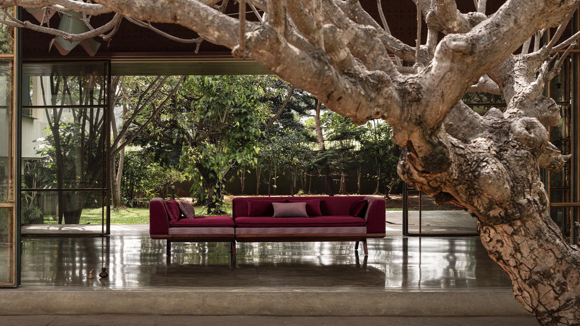 A wide shot of the Krithi Daybed, placed as a central statement piece in a contemporary home setting, embodying comfort and sculptural elegance.